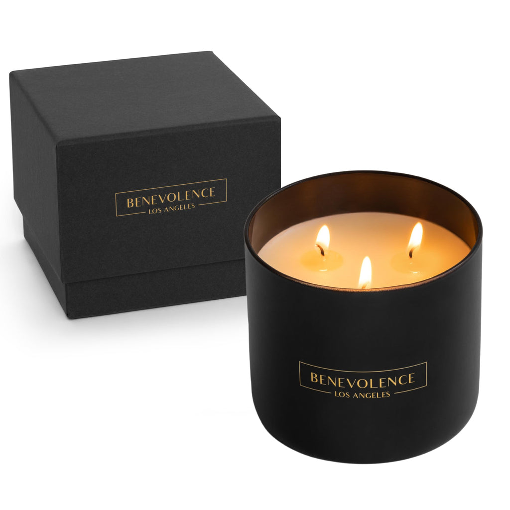Black candle with 'Benevolence Los Angeles' branding next to a matching black box on a white background.